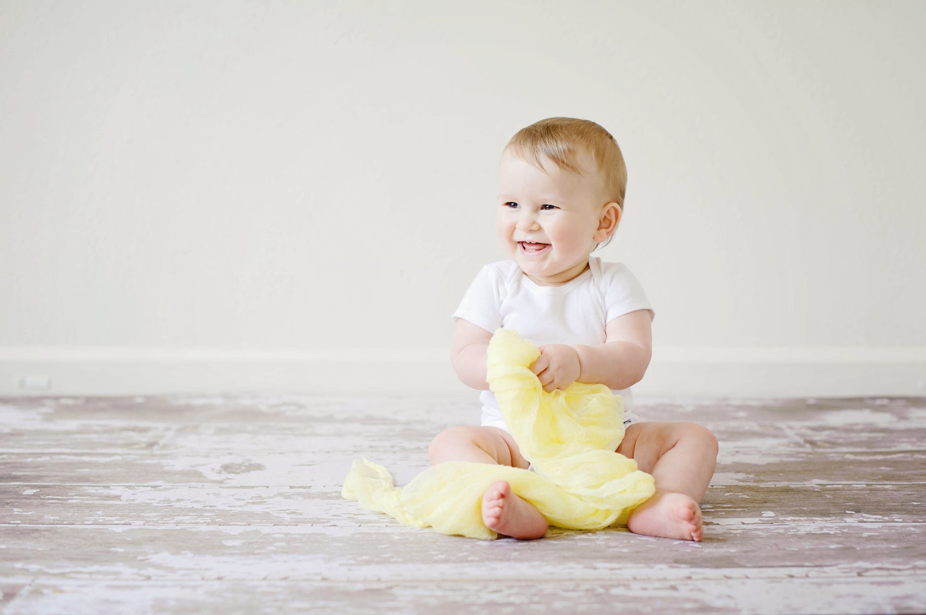 toddler sitting while smiling